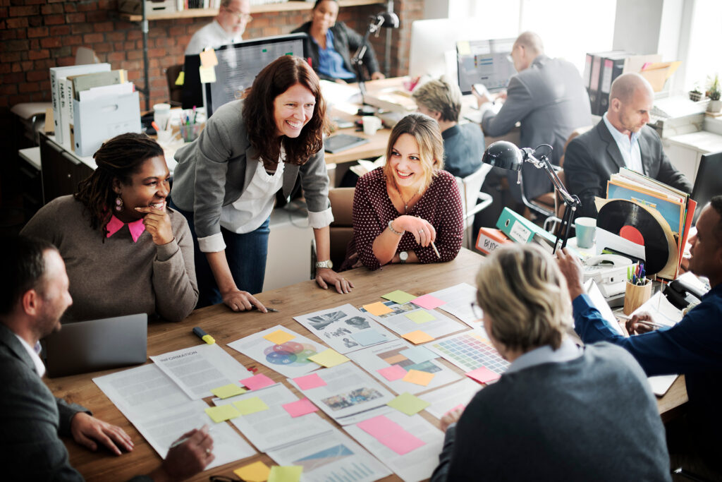 People sitting around a desk and collaborating.