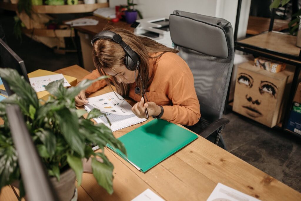 Woman Listening to Music While Reviewing Work