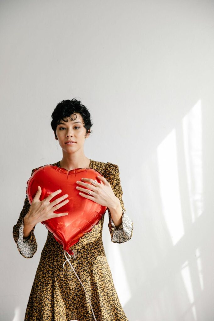 Woman Standing With Heart Balloon