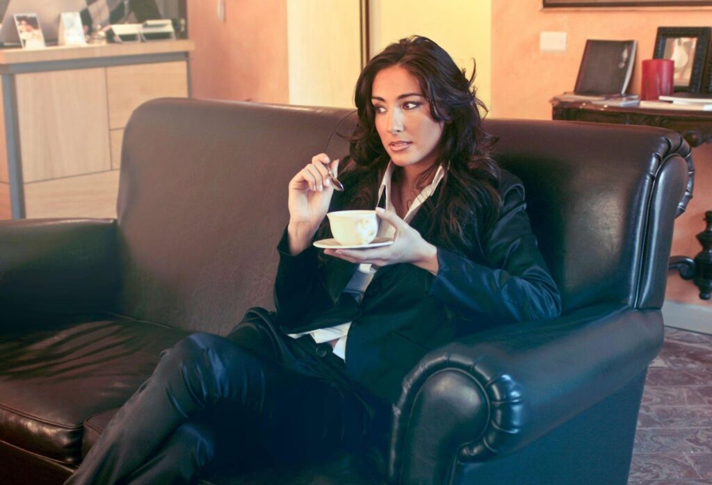 Woman Sitting on Couch with Coffee Mug