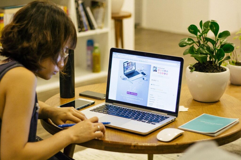 Woman Sitting at Table with Laptop