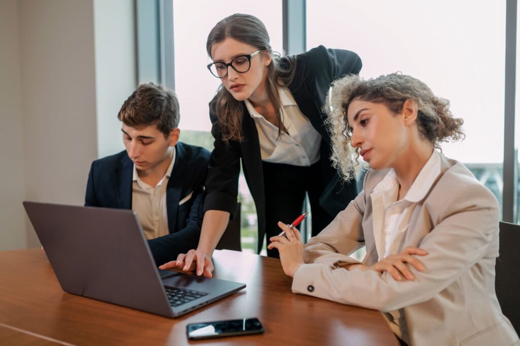 A team working together in an office, seated around a shared desk