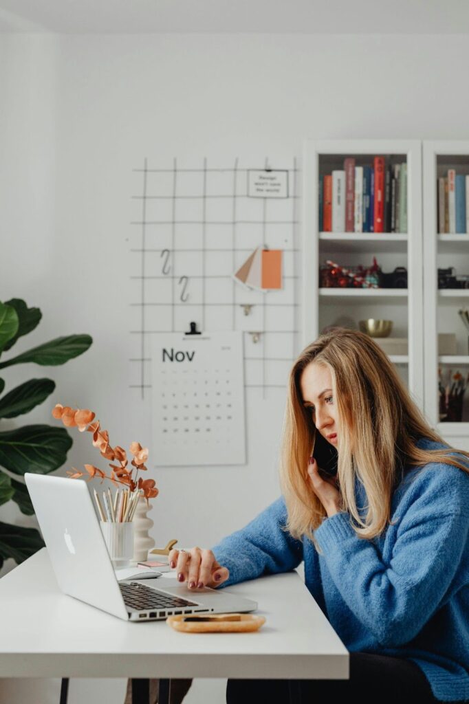 Woman Sitting at a Desk on the Phone